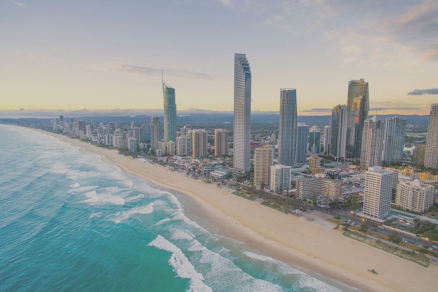 Aerial view of the Gold Coast coastline and Surfers Paradise skyline at sunrise